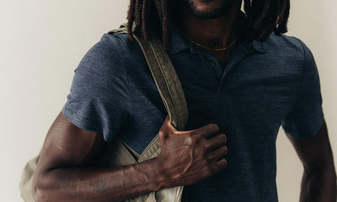 fit model posing in The Merino Polo in Heather Navy