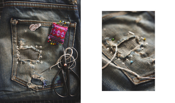 Close up of thread patching up a hole in jeans