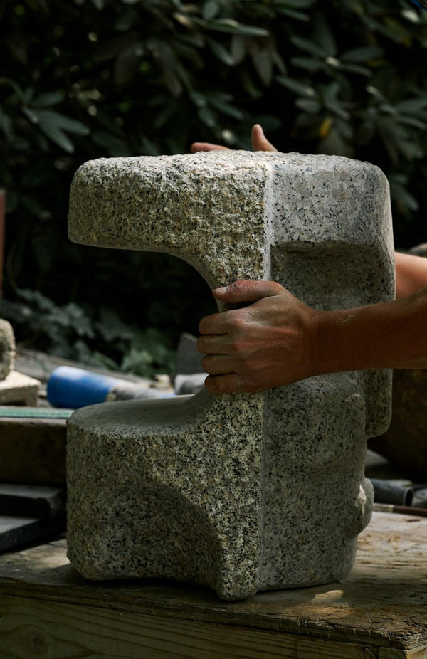 Matt Byrd holding stone carvings