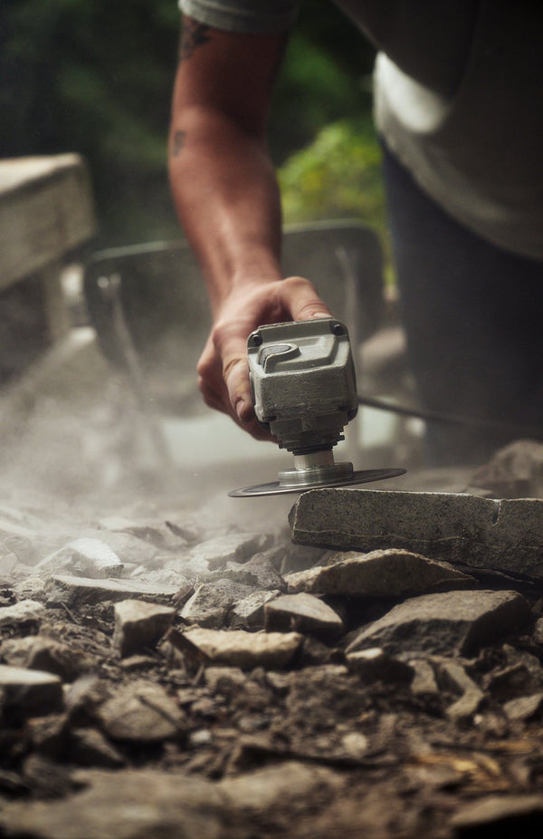image of Matt Byrd sanding down a stone