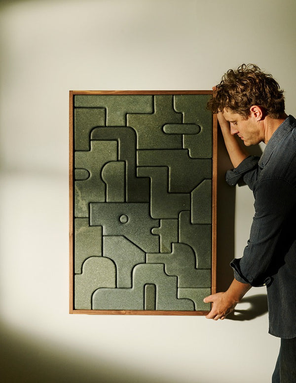 Matt Byrd placing stone carving on wall