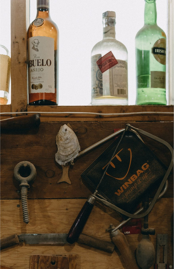 Glass bottles and boatmaking materials at The Old Wharf Dory