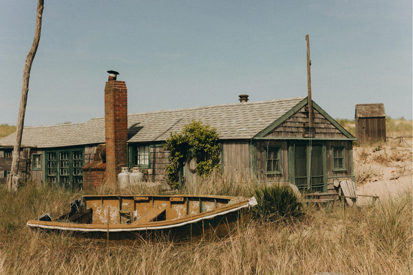 The exterior of The Old Wharf Dory, with a wooden boat out front