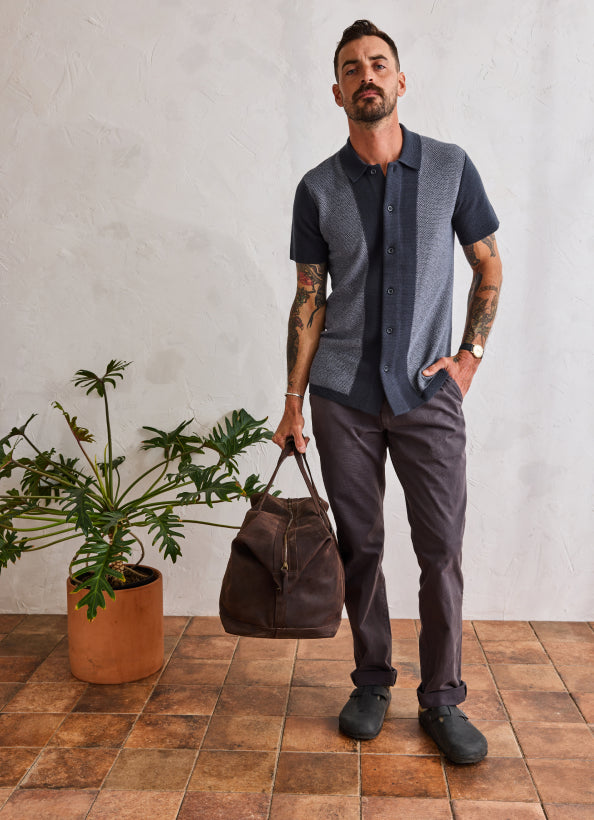 Model wearing The Button Down Polo in Marine Seed Stitch and The Foundation Pant in Organic Coal