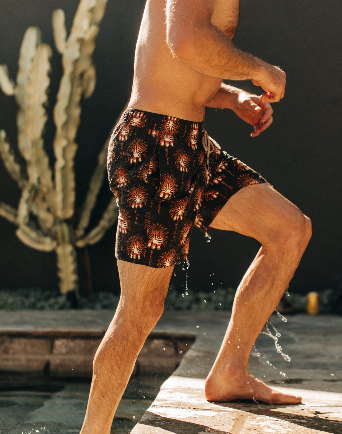 Model stepping out of the pool in The Bayberry Trunk in Mirage Palm