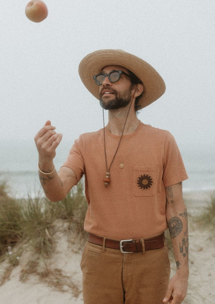 Daren tossing an apple in the air in The Embroidered Heavy Bag Tee