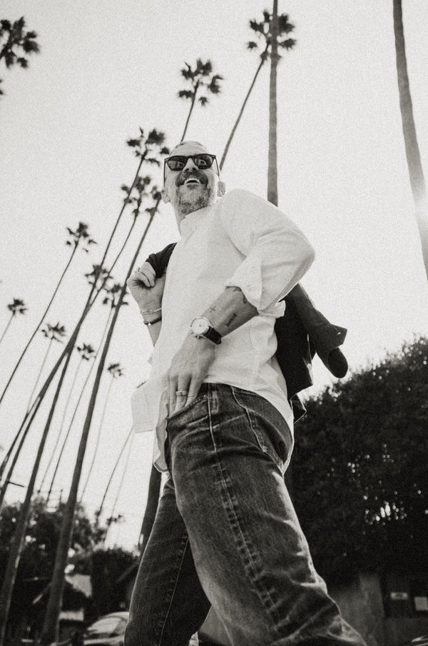 Model walking beneath palm trees, wearing The jack in Oxford