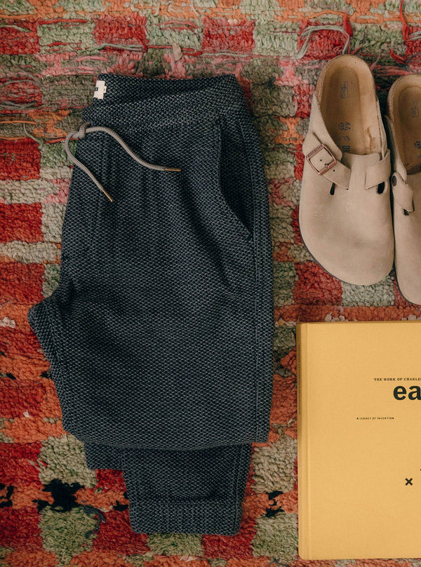 The Après Pant in Charcoal Sashiko, folded on a carpet