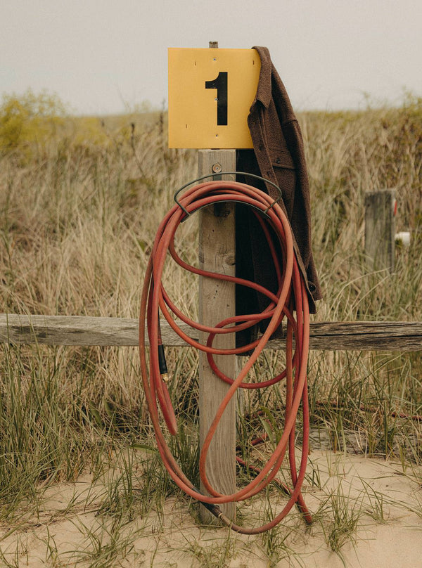 The Ledge Shirt hanging on a gas pump