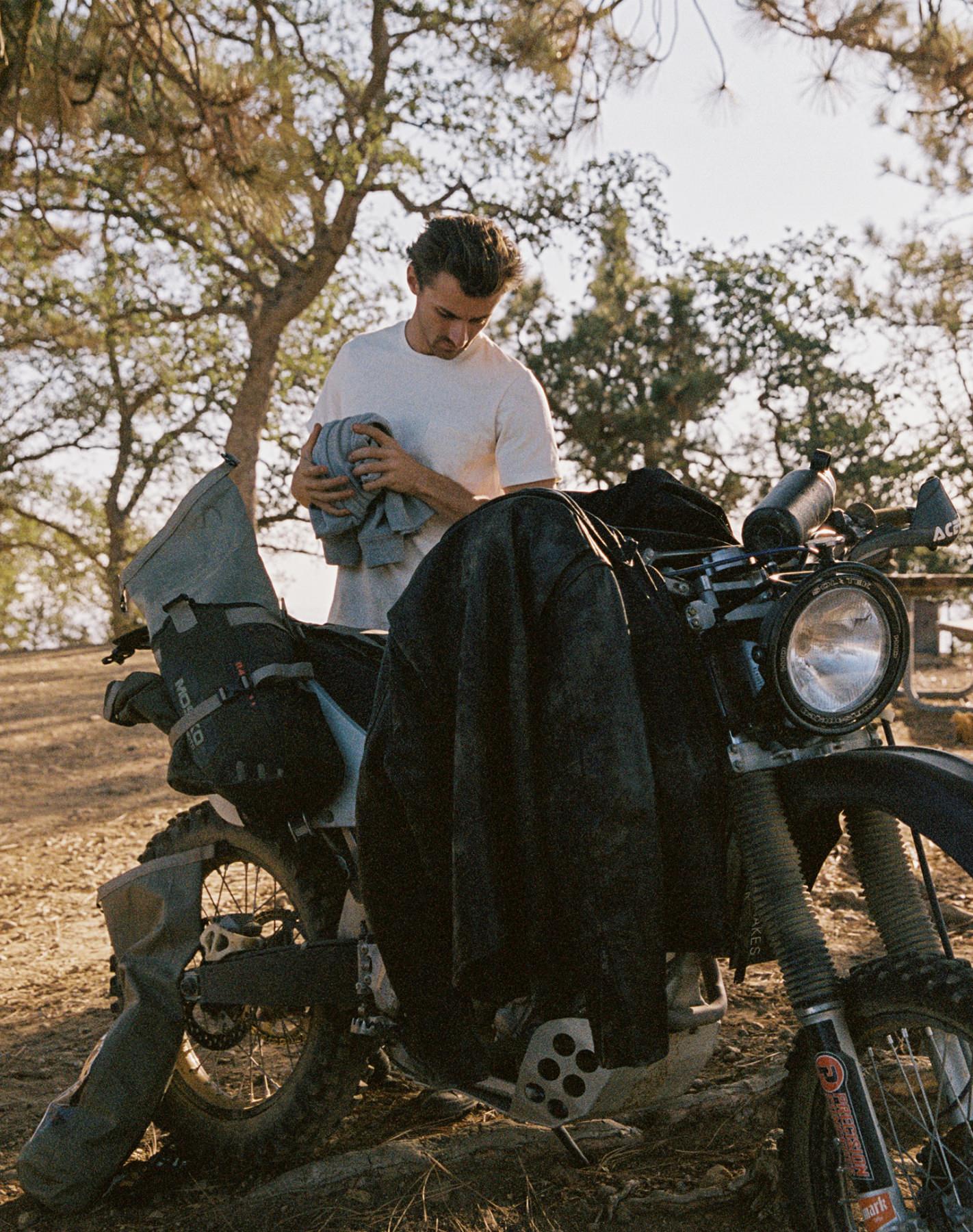 Wilderness Collective member with his bike and The Moto Jacket in Black Steerhide